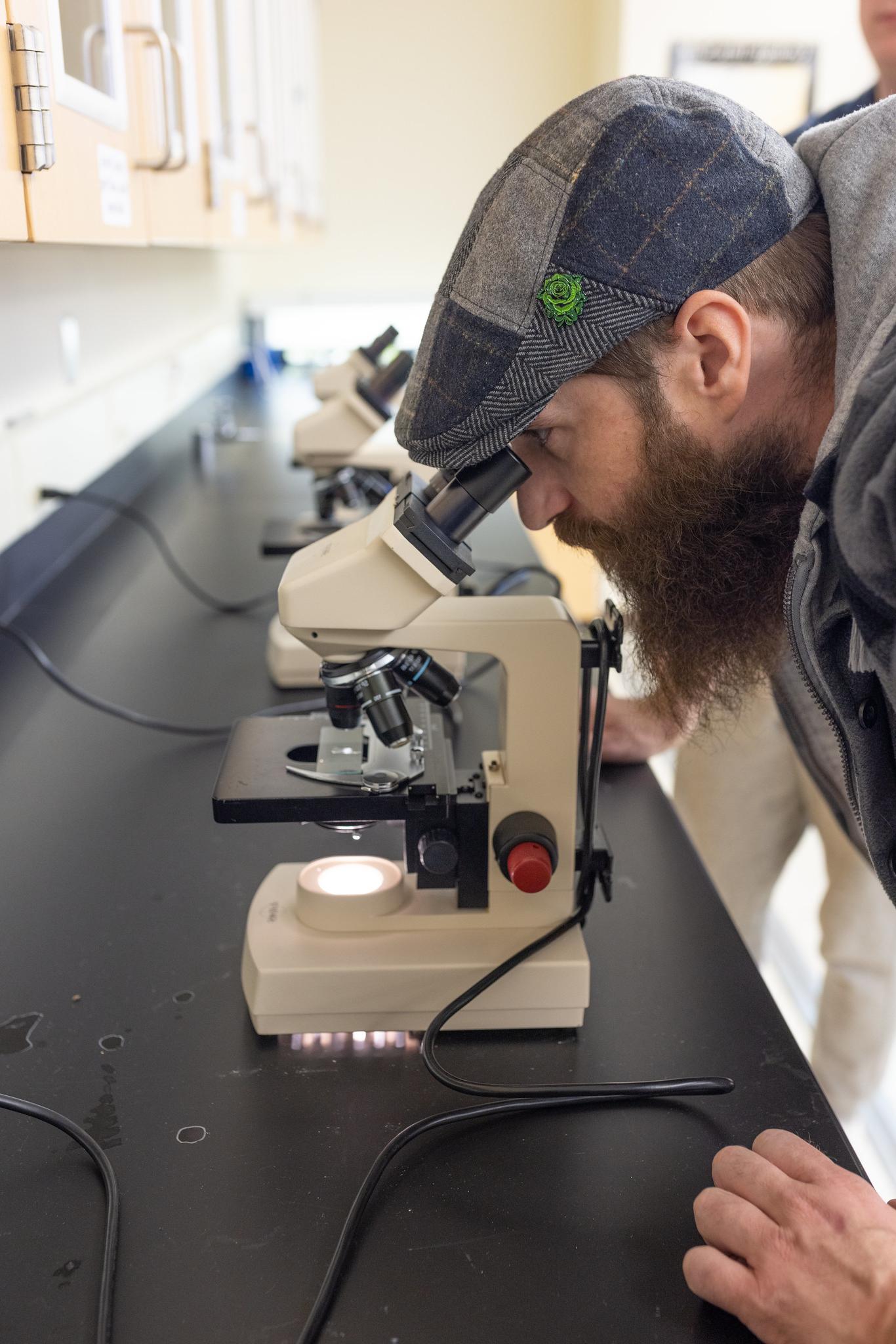 photo of a student using a microscope
